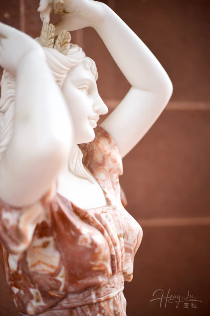 Marble-statue-woman-with-raised-arms