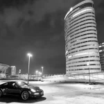 Black Porsche 911 with glowing tail lights A-black-Porsche-in-an-empty-parking-lot