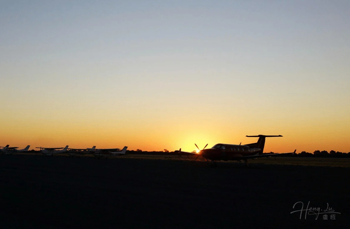 Airplanes-parked-on-runway-with-Africa-sunset-in-background