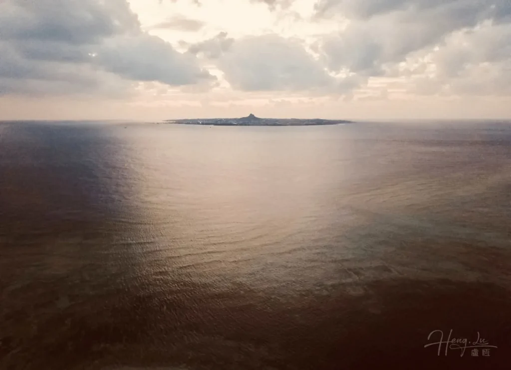 Distant-island-viewed-over-calm-sea (1)