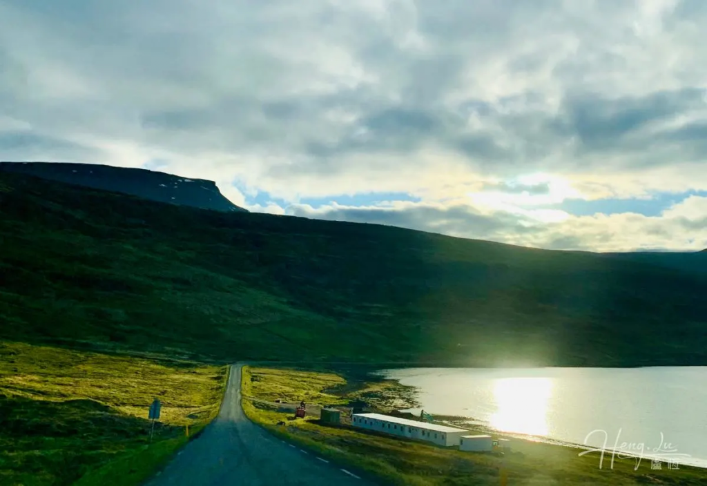 Scenic-Iceland-road-leading-to-lake-with-sunlight