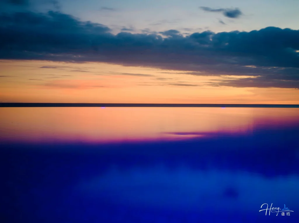 Tranquil-sunset-reflects-soft-colors-over-calm-water-horizon
