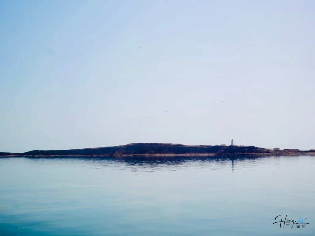 Calm-seascape-with-distant-lighthouse
