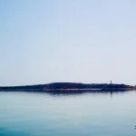 Calm-seascape-with-distant-lighthouse