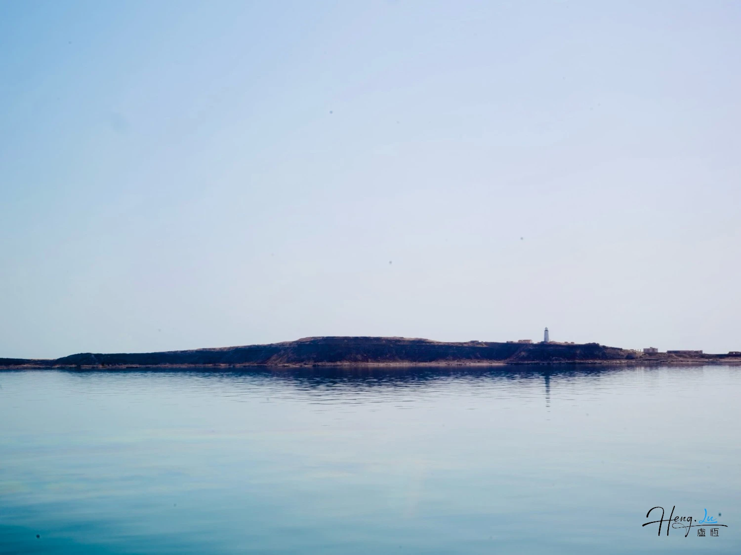 Calm-seascape-with-distant-lighthouse