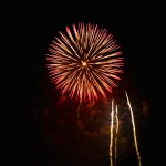 Fiery-red-firework-blooms-like-sunburst-against-midnight-sky