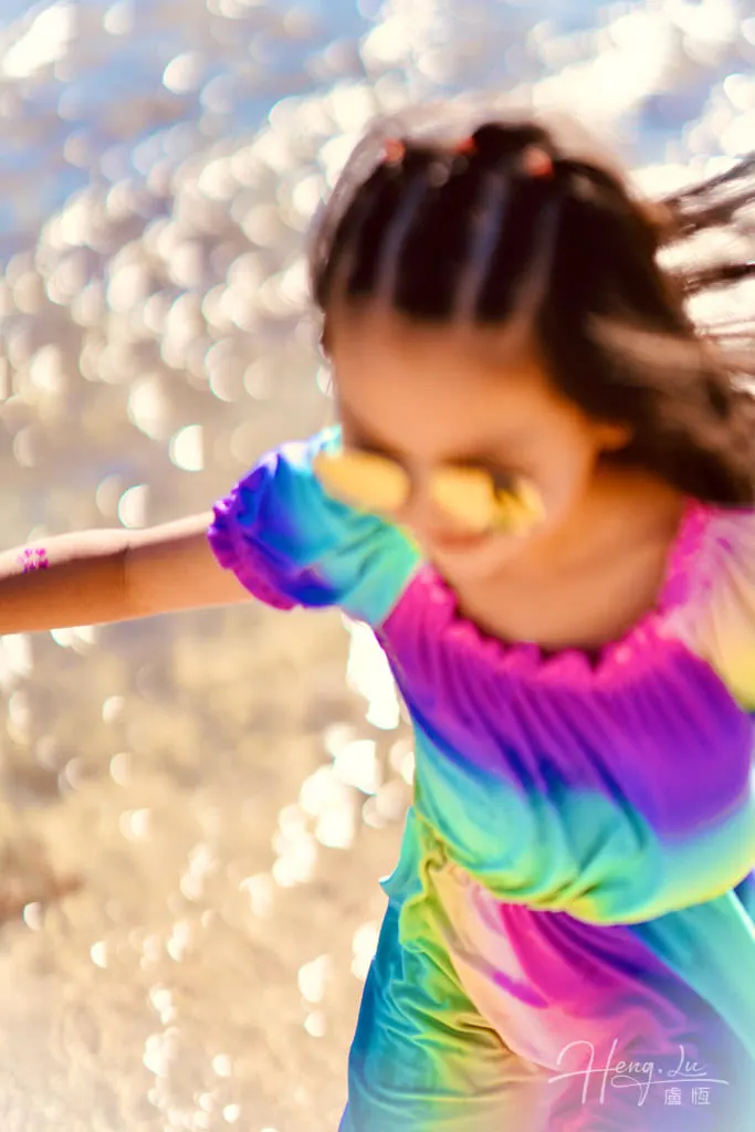 Colorful joy by the water Girl-in-Rainbow-dress