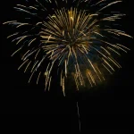 Golden-and-blue-firework-bursts-gloriously-against-dark-midnight-sky