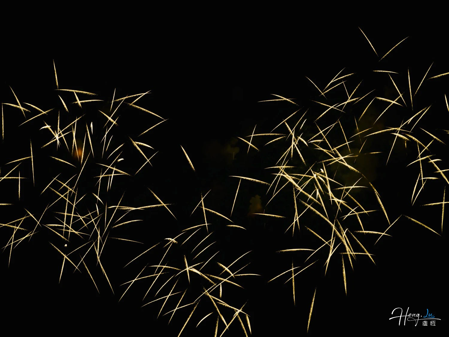 Golden-spark-trails-crisscross-beautifully-against-dark-night-sky