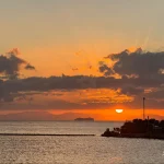 Golden-sunset-over-sea-with-distant-ship
