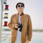 Luheng-holding-binoculars-on-boat-deck