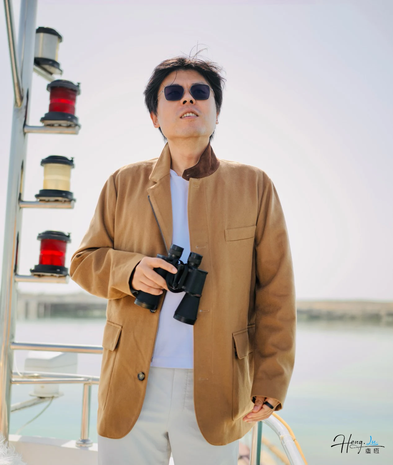 Luheng-holding-binoculars-on-boat-deck