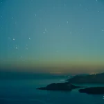 Night-sky-over-sea-and-distant-islands