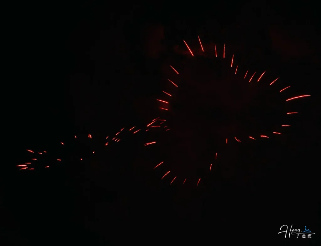 Red-firework-trails-forming-heart-shape-in-dark-sky