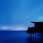 Silhouette-of-sea-villa-on-stilts-over-ocean