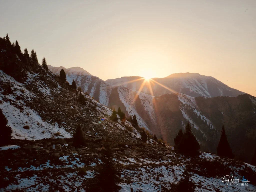 Sunrise-over-snowy-mountain-slopes-with-pine-trees