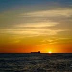 Sunset-in-Hawaii-over-ocean-with-ship-on-horizon