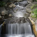 Tranquil-stream-flowing-over-rocks
