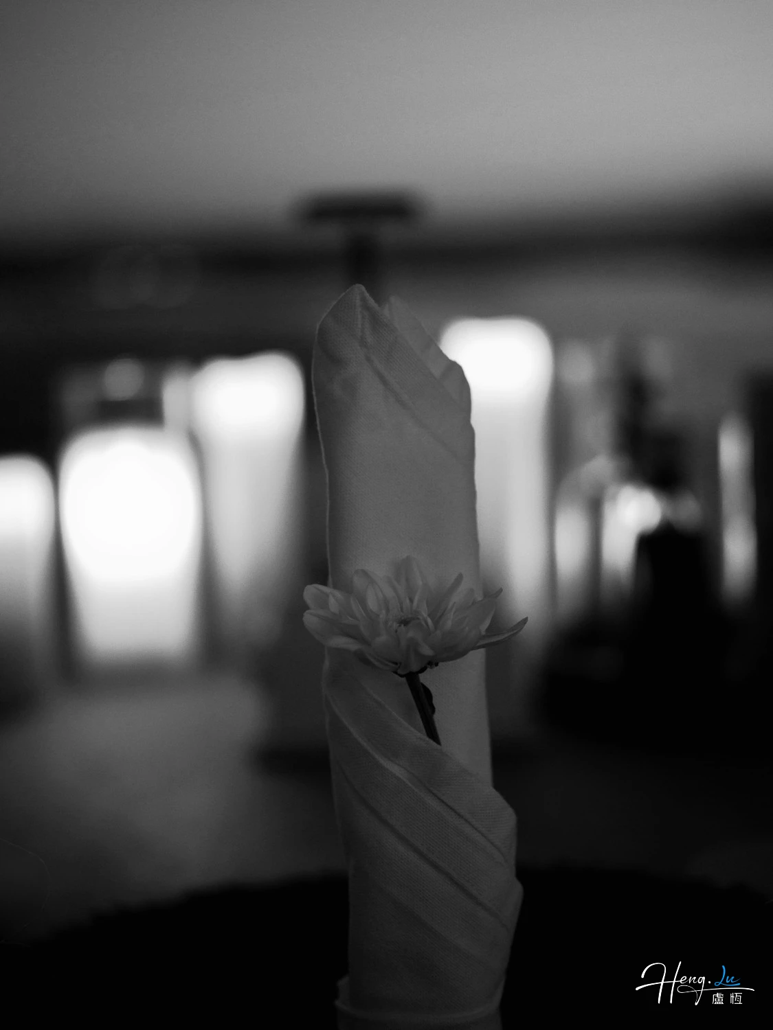 black-and-white-folded-napkin-holding-single-flower