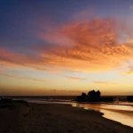 golden-sunset-with-colorful-clouds-over-seaside-wreck