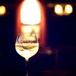 illuminated-wine-glass-on-bar-table-with-bokeh