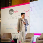 luheng-standing-on-itw-asia-stage-during-conference