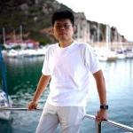 luheng-standing-on-yacht-with-marina-background