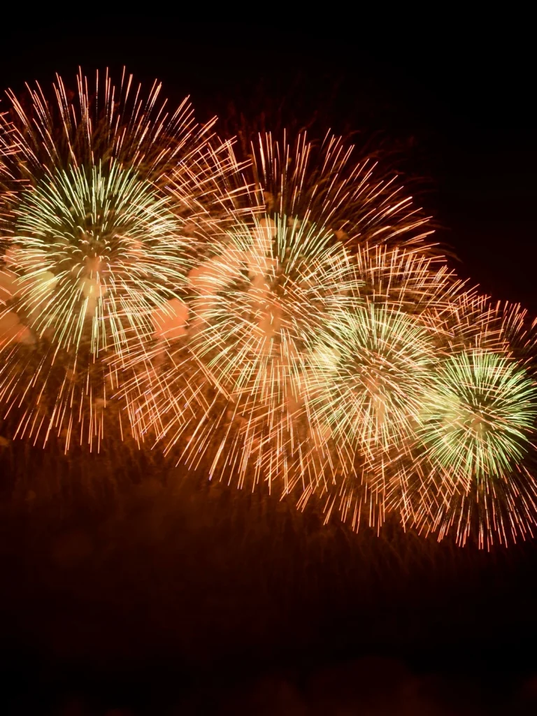 orange-and-green-fireworks-bursting-across-night-sky
