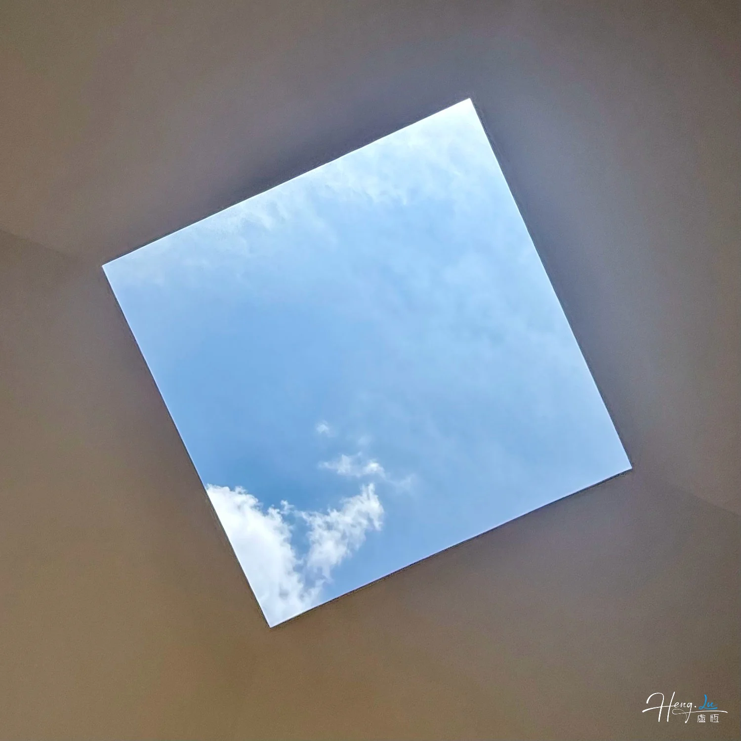 square-skylight-framing-blue-sky-with-white-cloud