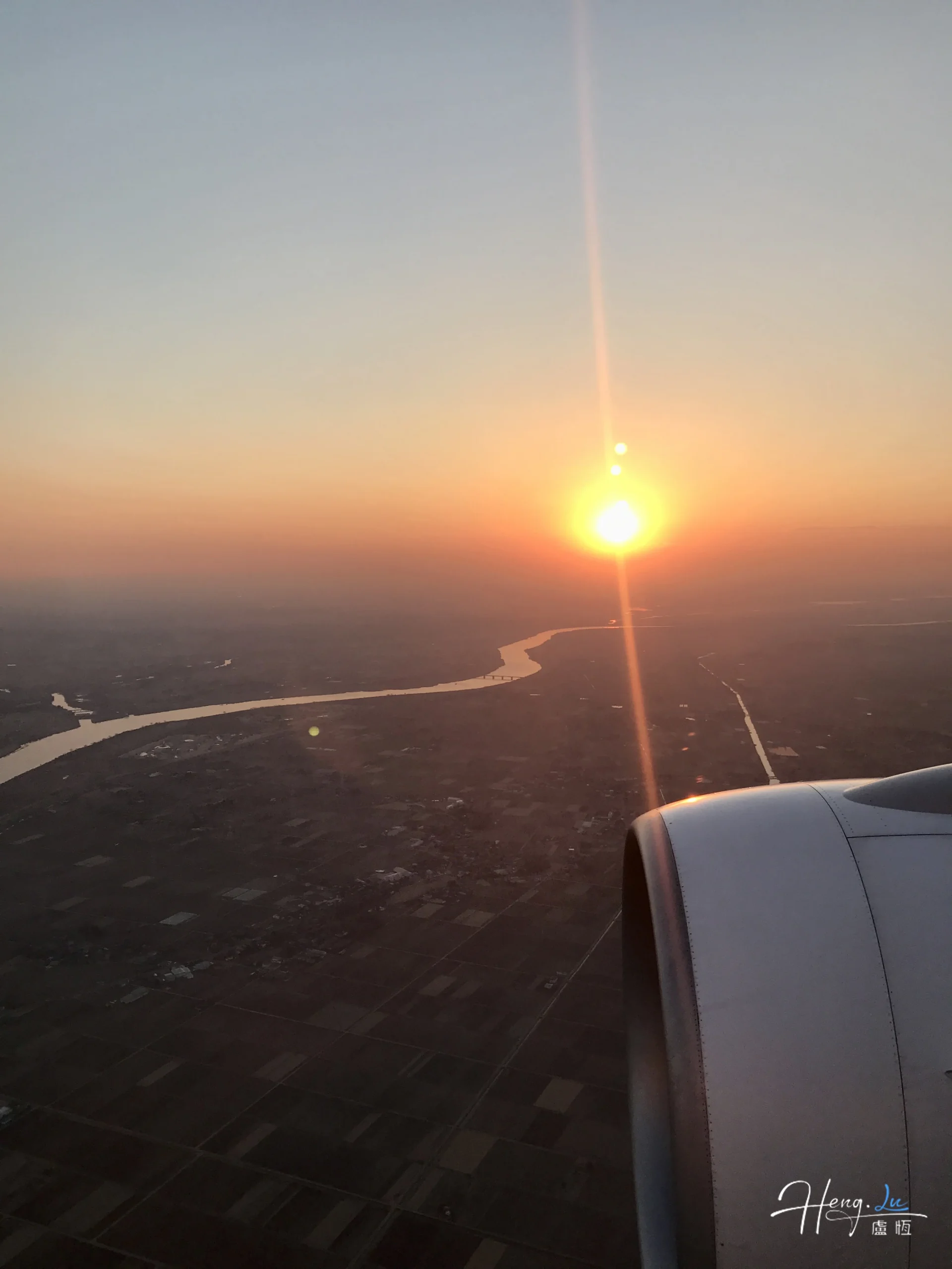 Airplane Wing Over River During Sunset Flight with Golden Sky airplane-wing-over-river-during-sunset-flight