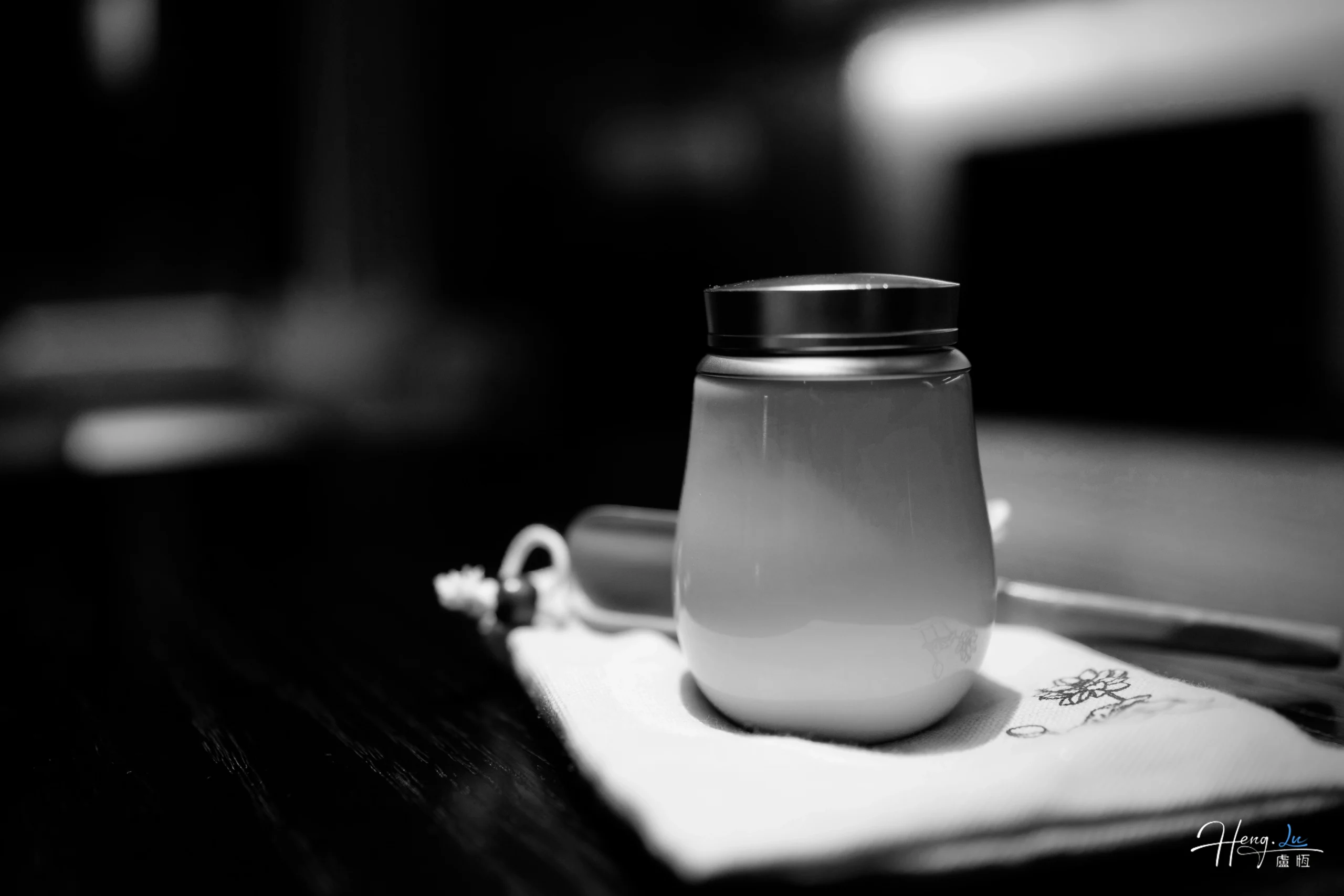 Black and white close up of ceramic cup on table black-and-white-close-up-of-ceramic-cup-on-table