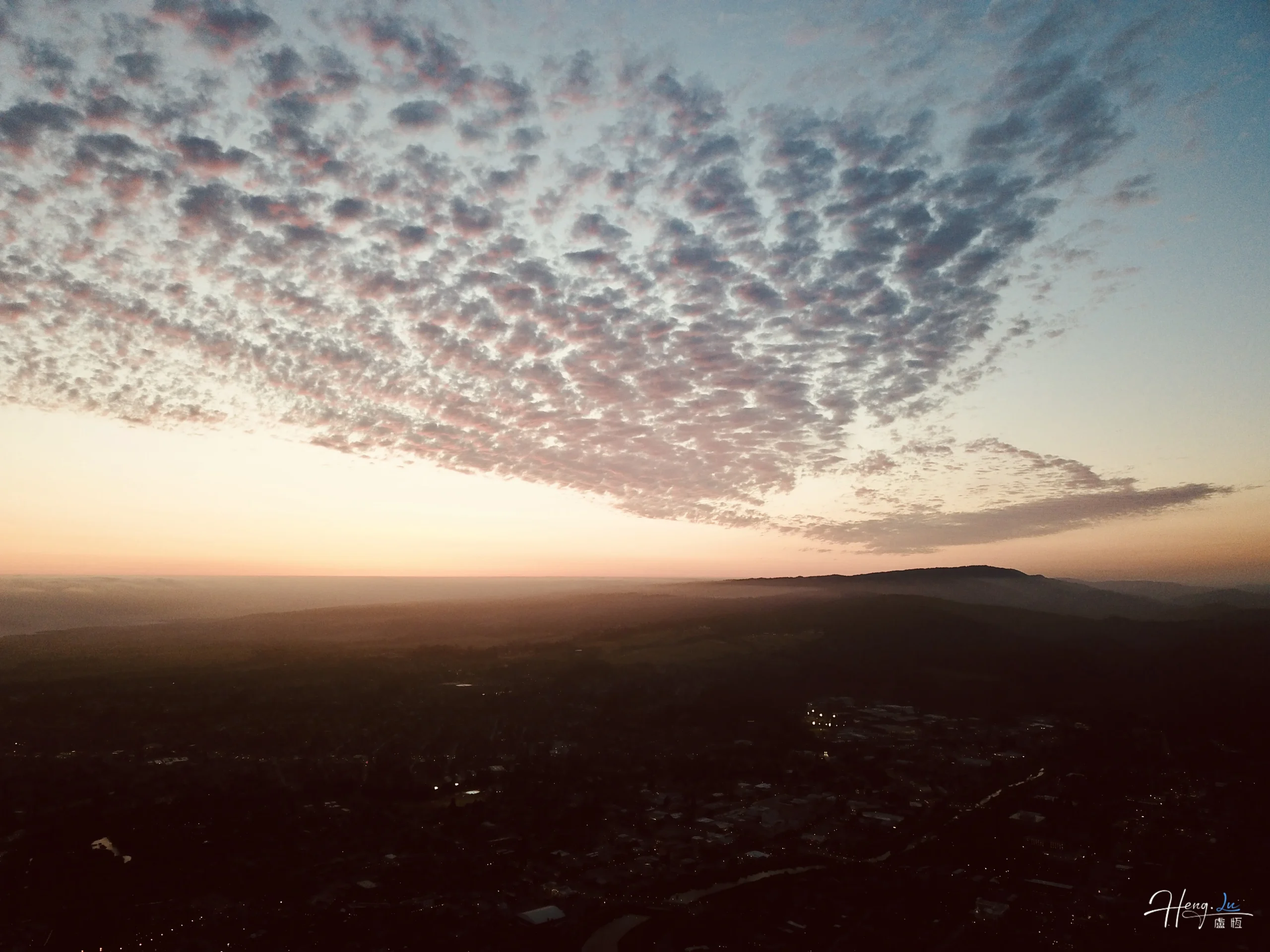 dramatic-sunset-sky-over-hill-and-cityscape