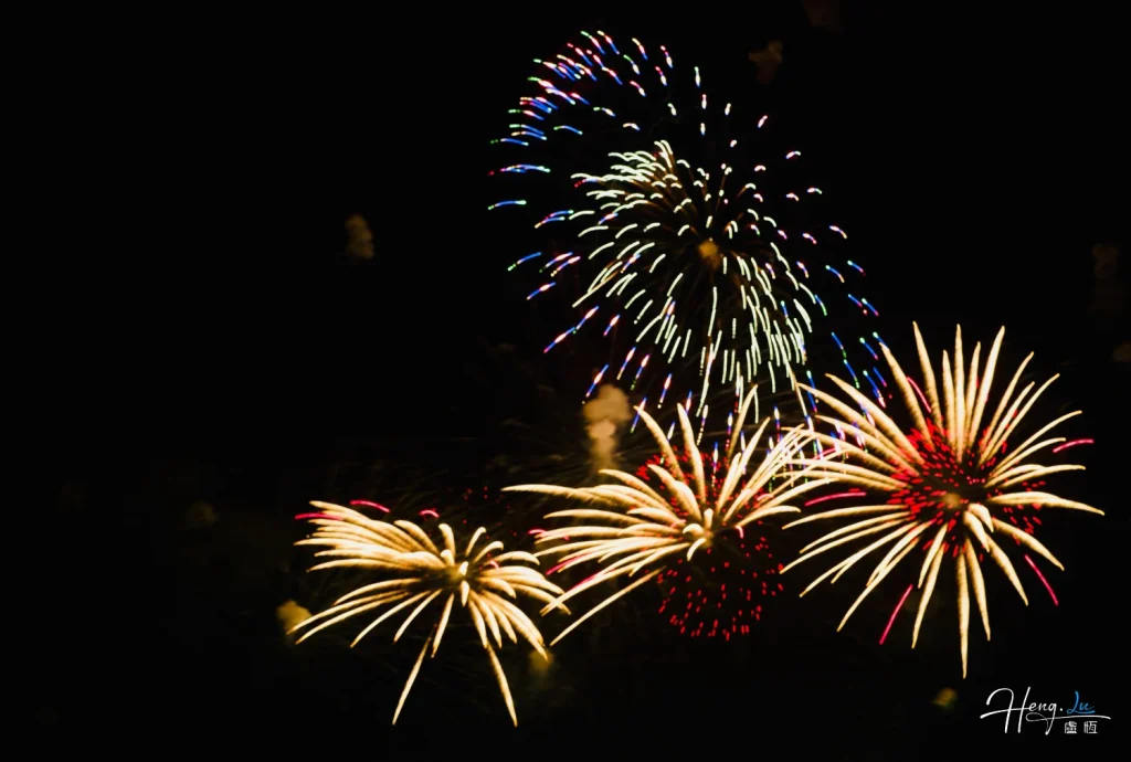 gold-and-red-fireworks-bursting-above-dark-sky