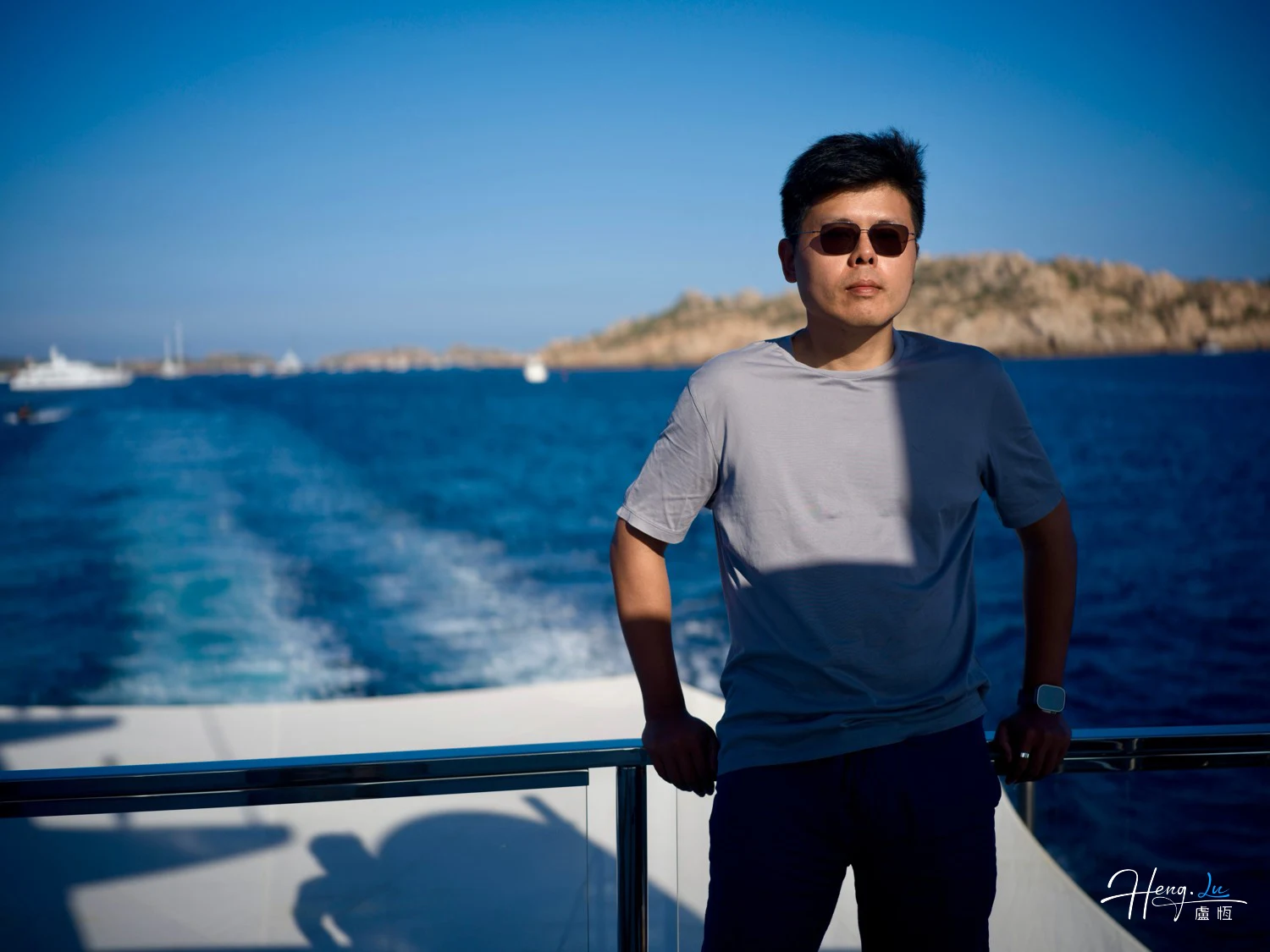 luheng-standing-on-boat-deck-with-blue-sea-view