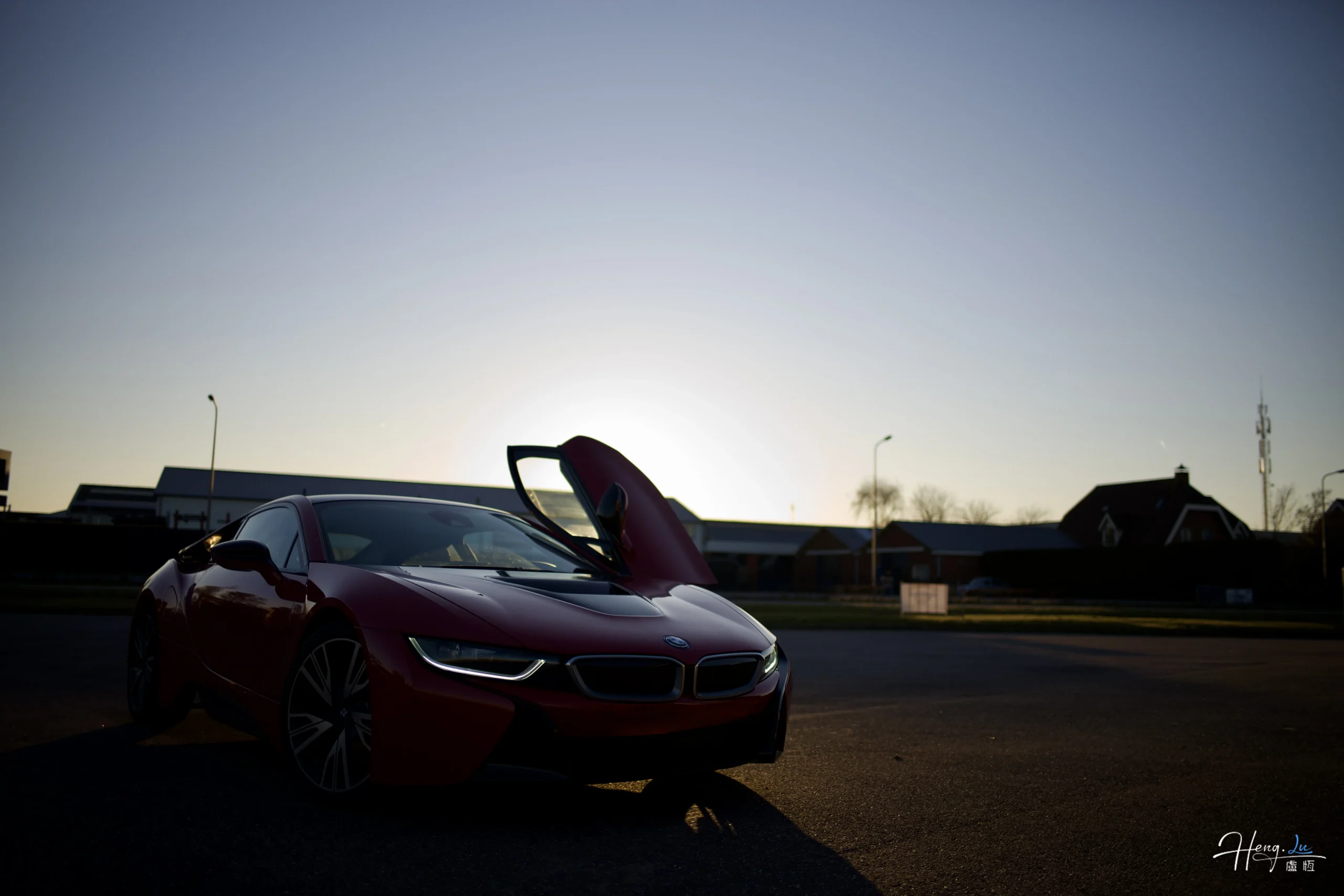 red-sports-car-parked-under-sunset-sky