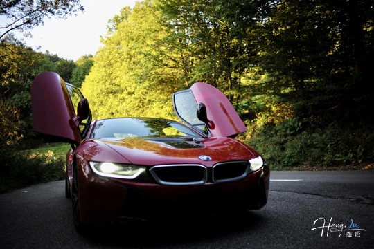 red-sports-car-with-open-gullwing-doors-on-forest-road