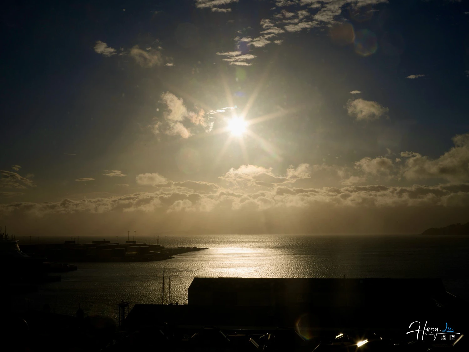 sunlight-shining-over-sea-and-harbor-at-dawn