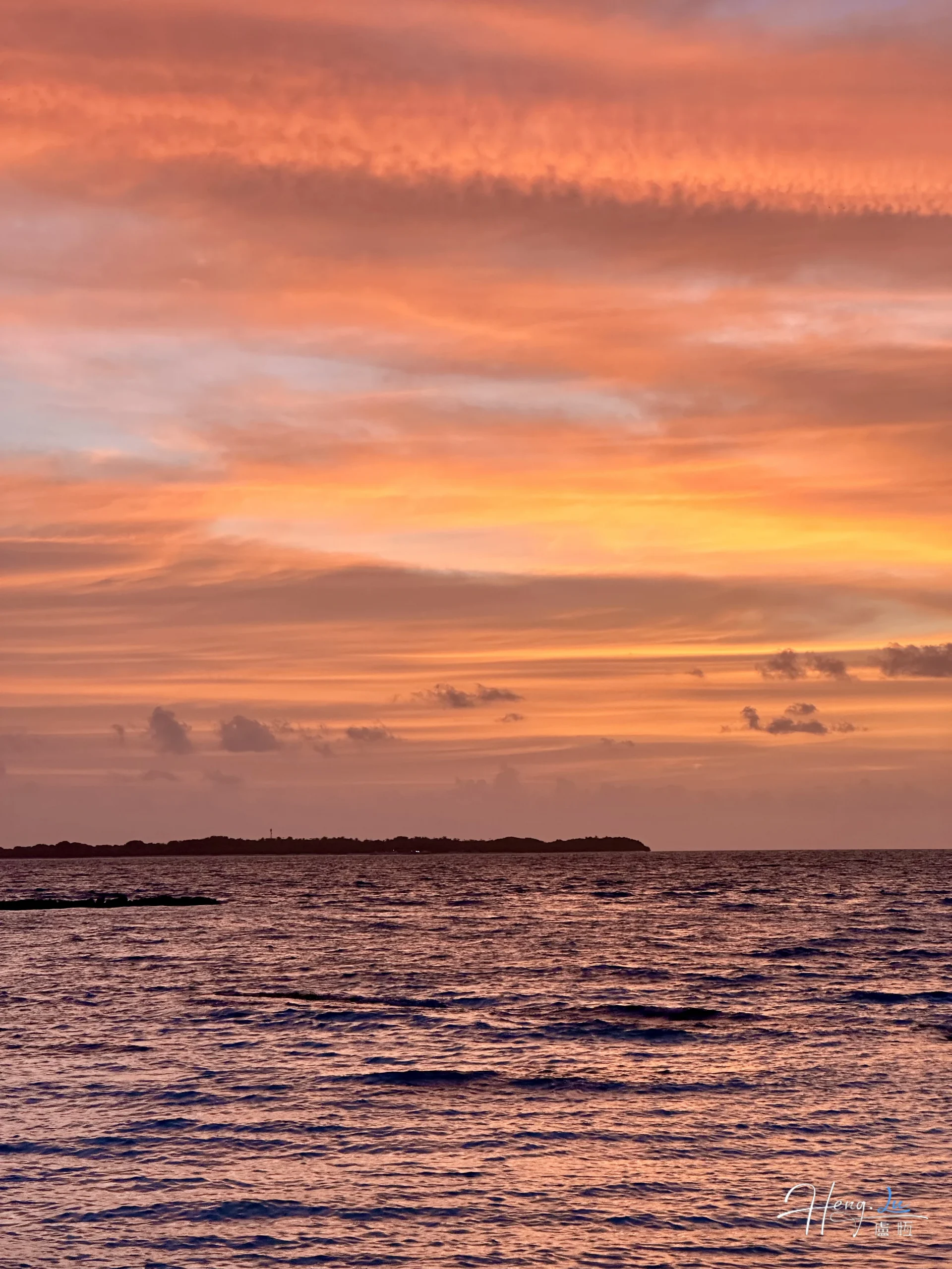 Sunset over ocean with golden clouds sunset