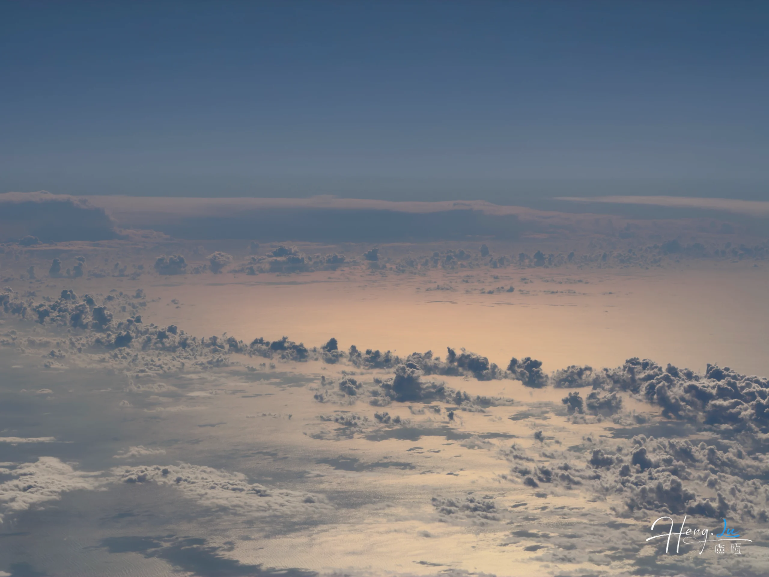 Aerial view of clouds above sunlit ocean aerial-view-of-clouds