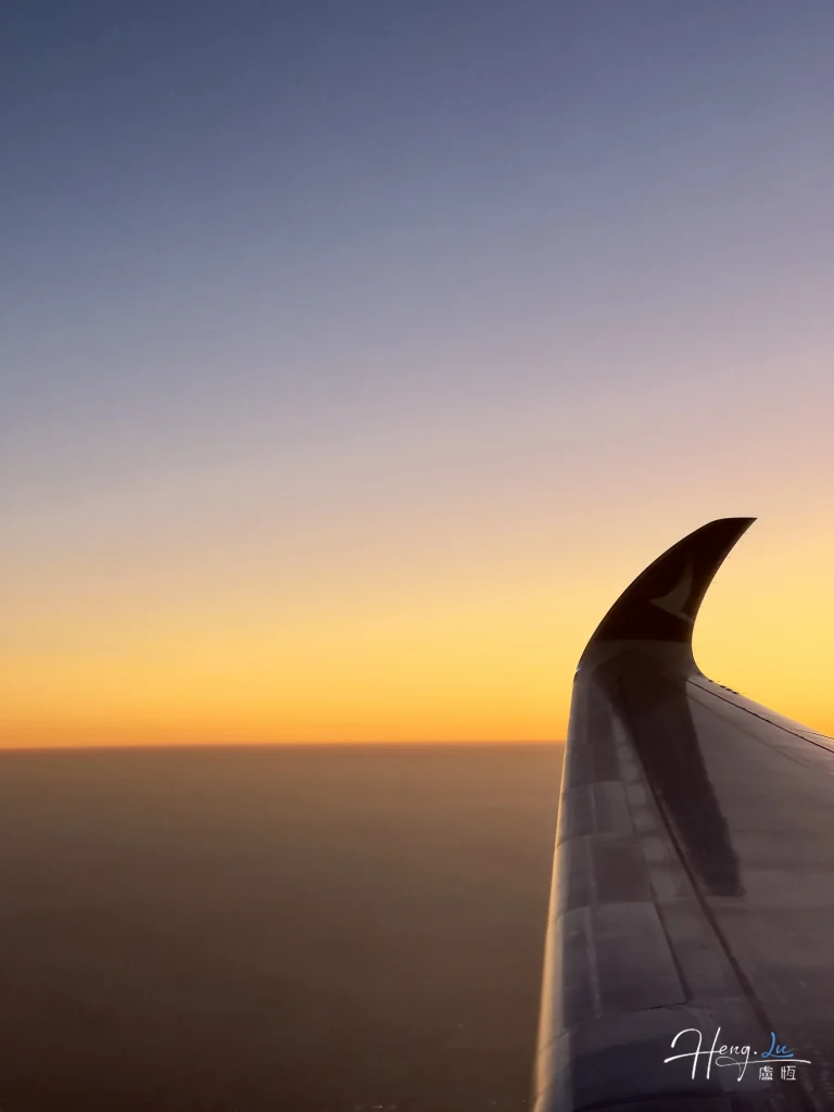 airplane-wing-over-sunset-sky
