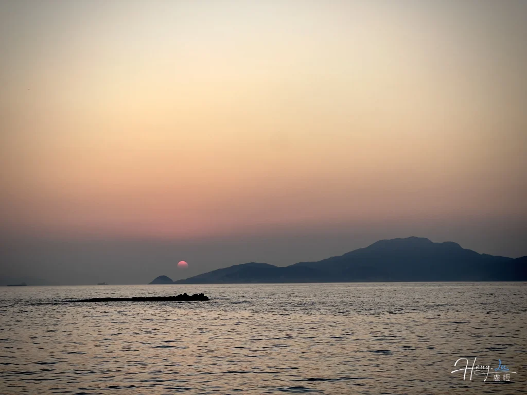 sunset-over-sea-with-distant-mountains