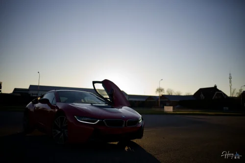 red-sports-car-parked-under-sunset-sky